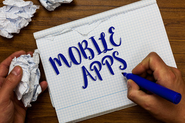 Conceptual hand writing showing Mobile Apps. Business photo showcasing small programs are made to work on phones like Android or ios Man holding marker notebook crumpled papers ripped pages.
