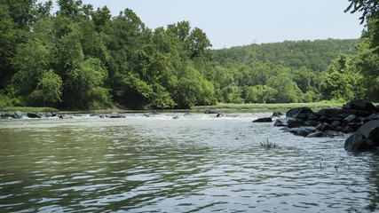 Fototapeta na wymiar River in eastern Oklahoma with rocky shores and lush green trees