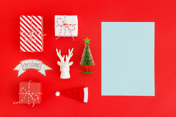 Gifts and christmas decorations on red background.