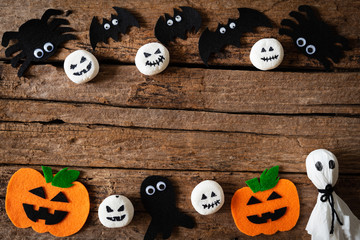 Top view of Halloween crafts, orange pumpkin, ghost and spide on wooden background with copy space for text. halloween concept.