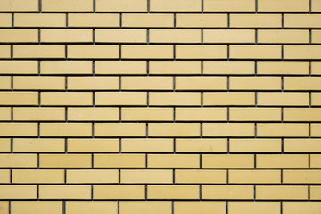Brick wall of a new brick of yellowish tint