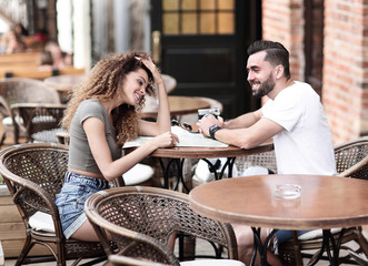 Beautiful loving couple sitting in a cafe enjoying in coffee