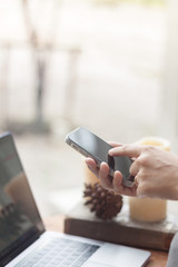 Woman using smart phone in coffee shop