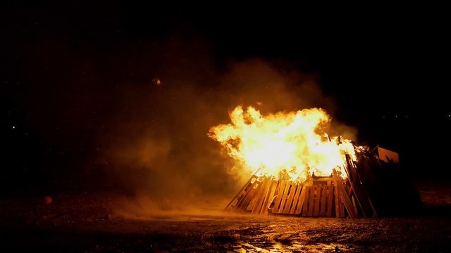 Large bonfire on mudflat at low tide to celebrate guy fawkes night