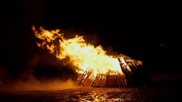 Large bonfire on mudflat at low tide to celebrate guy fawkes night