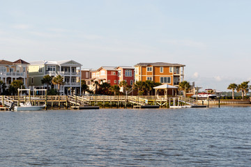 Wide angle view of Luxury beach houses with boat dock on the inter coastal waterway, Sunset Beach,...