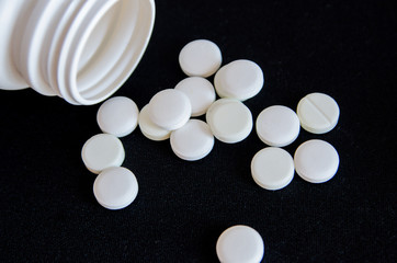 tablets are scattered on the table, dosage for the patient
