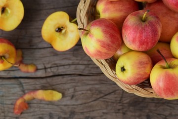ripe red apple in rattan basket with apple slices on old rustic wood background top view from above flat lay with copy space 