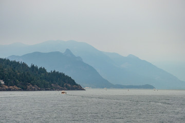 layered Mountains behind Island under the smoky morning