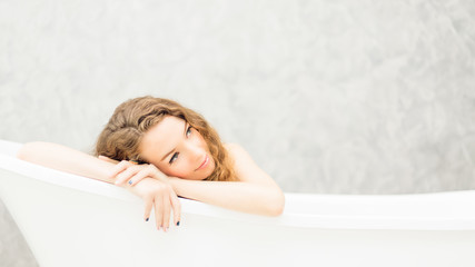 Young woman relaxing in bath.beautiful woman lying in bathtub.