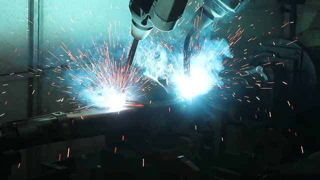 Automation welding mechanical procedure.,Industrial Robot arm active in factory