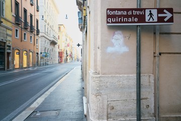 Rome,Italy-July 29 2018: Directional arrow for Trevi Fountain displayed at the corner of Corso...