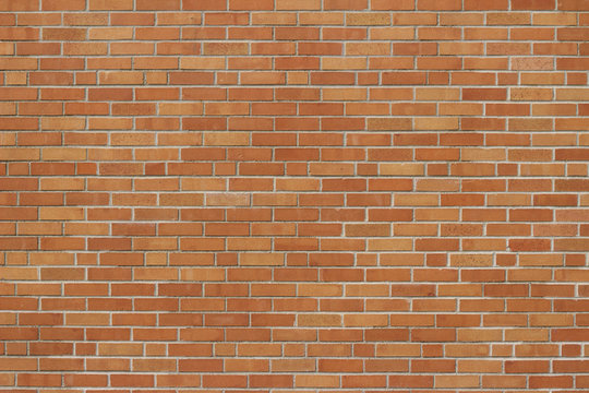 Fototapeta Vintage orange yellow brick wall background with a weathered exterior in a Flemish stretcher bond pattern