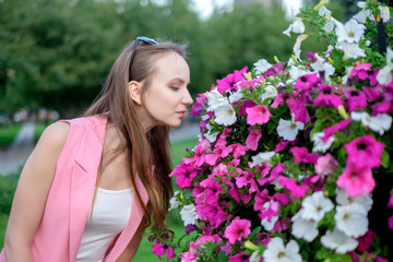 Side profile of young woman smelling blossoms