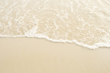 Fototapeta na wymiar Soft wave of blue and green ocean/sea on sandy beach. Empty copy spac background.
