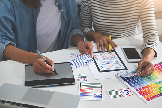 Creative Web Designer planning application and developing template layout, framework for mobile phone. User experience (UX) concept.