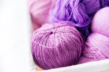 top view of colored yarn balls and knitting needles