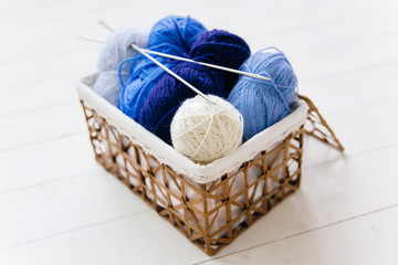 Fototapeta na wymiar top view of colored yarn balls and knitting needles