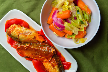 Sardines in sauce and salad