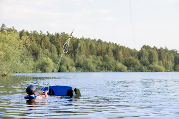 Young man riding wakeboard on a lake