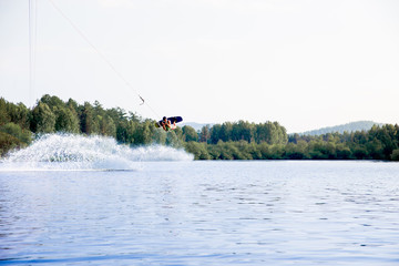 Young man riding wakeboard on a lake