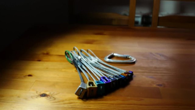 Climbing nuts and a carabiner on a wood table