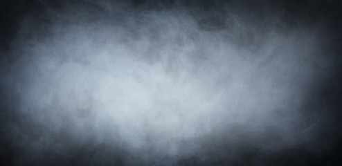 Grey smoke over black background. Abstract background.