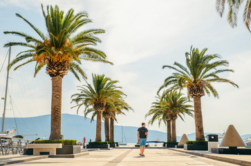 Fototapeta premium man walking by pier in summer day