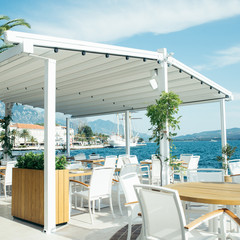 cafe with beautiful view at blue sea water. mountains on background