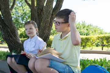 the boy and the girl pondered the solution of the task on the street