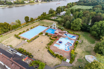 Aerial view of empty open-air swimming pool in Germany with no people beside the rhine river in Bonn