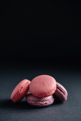 pink macarones on dark background