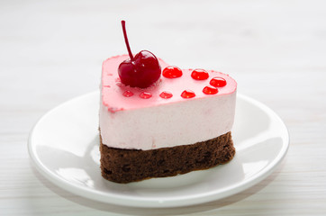 nice small cake in the form of heart  on the table