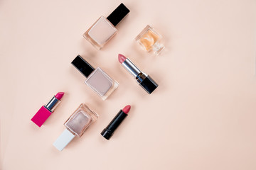 Obraz premium Creative flat lay of fashion bright nail polishes and decorative cosmetic on a colorful background. Minimal style. Copy space. Beauty blogger concept. professional makeup.Top view.Copy space