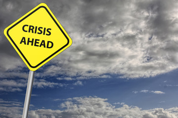crisis ahead sign with stormy sky as the background