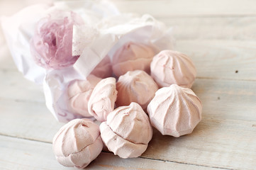 Tasty pink zephyr on a wooden table. It can be used as a background