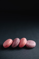 pink macarones on dark background