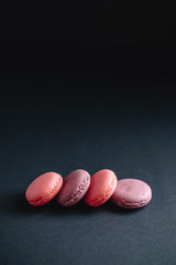 pink macarones on dark background
