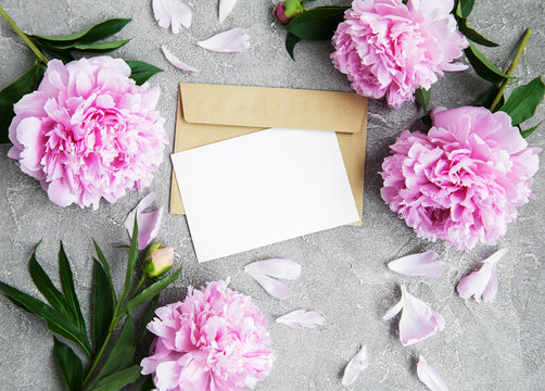 invitation card, craft envelope and pink peony flowers