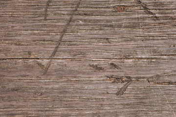 Close up of old weathered wooden planks with cracks and scratches as texture. Abstract natural background