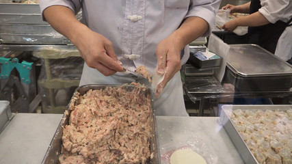  Man or chef  hand is making dim sum. by dumpling wrappers.