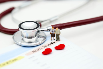 Miniature people : Doctor and patient Cardiogram with stethoscope and red heart,A heart beats graph...