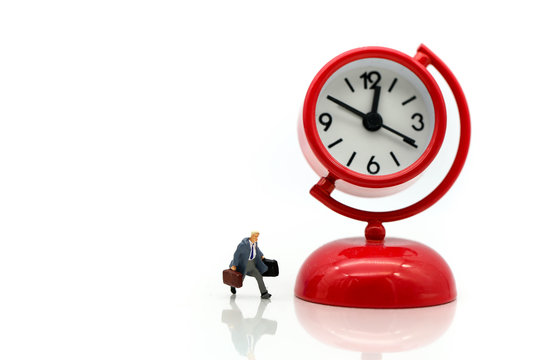 Miniature people : Businessman watching the time using for concept Be Late For Something Day.