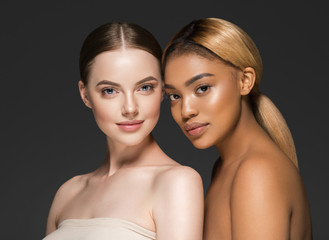 Ethnic beauty skin two women beauty face healthy skin and different colors african and caucasian