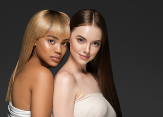 Ethnic beauty skin two women beauty face healthy skin and different colors african and caucasian