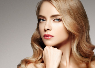 Beautiful woman with long curly blonde hair perfect hairstyle beauty female portrait face