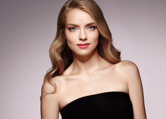 Fototapeta premium Beautiful woman with long curly blonde hair perfect hairstyle beauty female portrait face