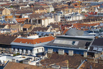 Fototapeta premium Red and blue shade tiles on close up city building roof