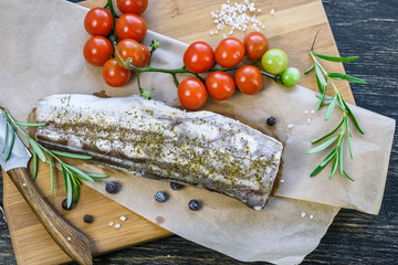 Fresh fish with tomatoes, rosemary and spices.