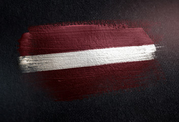Latvia Flag Made of Metallic Brush Paint on Grunge Dark Wall - obrazy, fototapety, plakaty